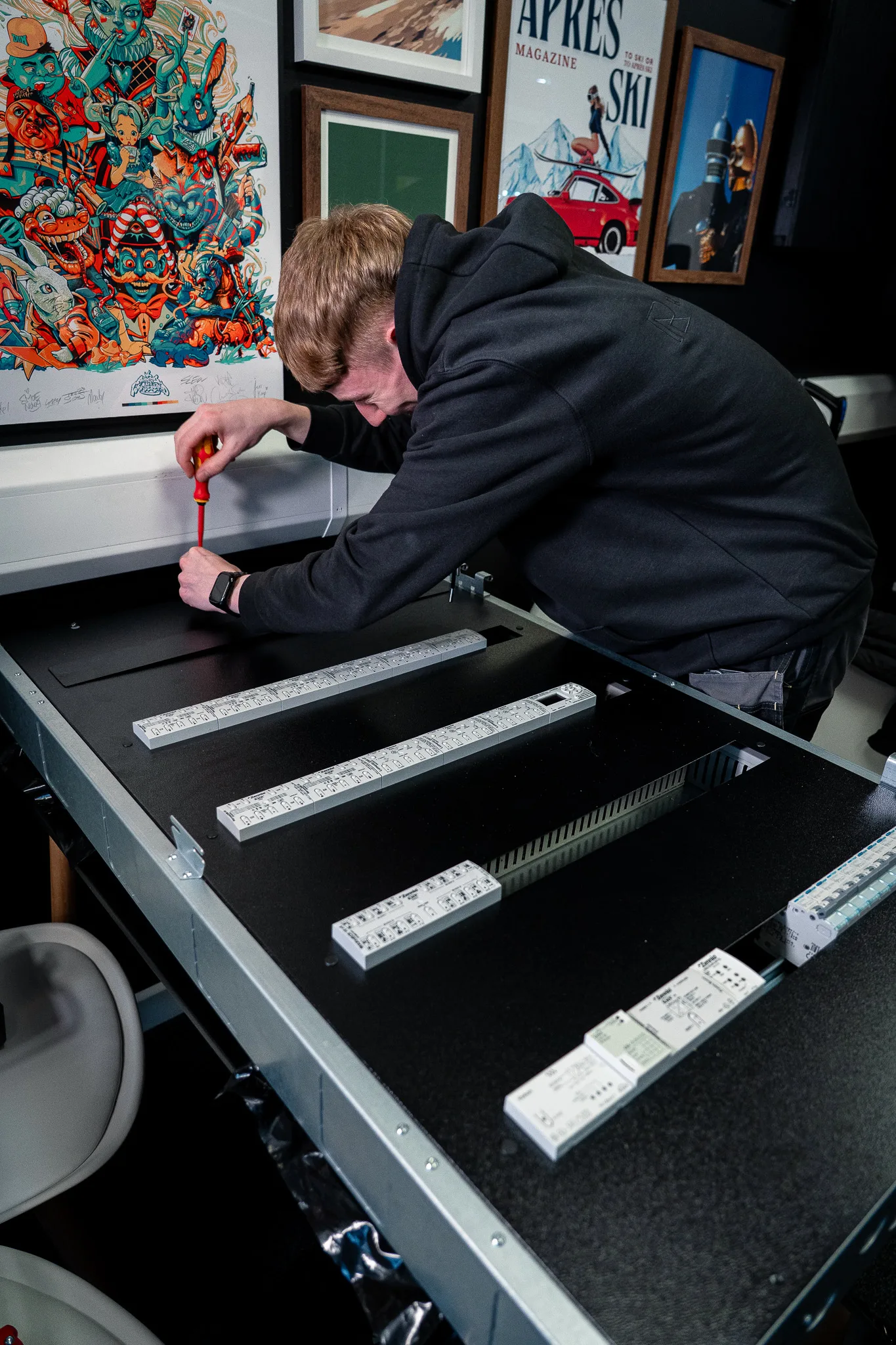 An engineer building a KNX panel on the bench at Hawkshaw Farm
