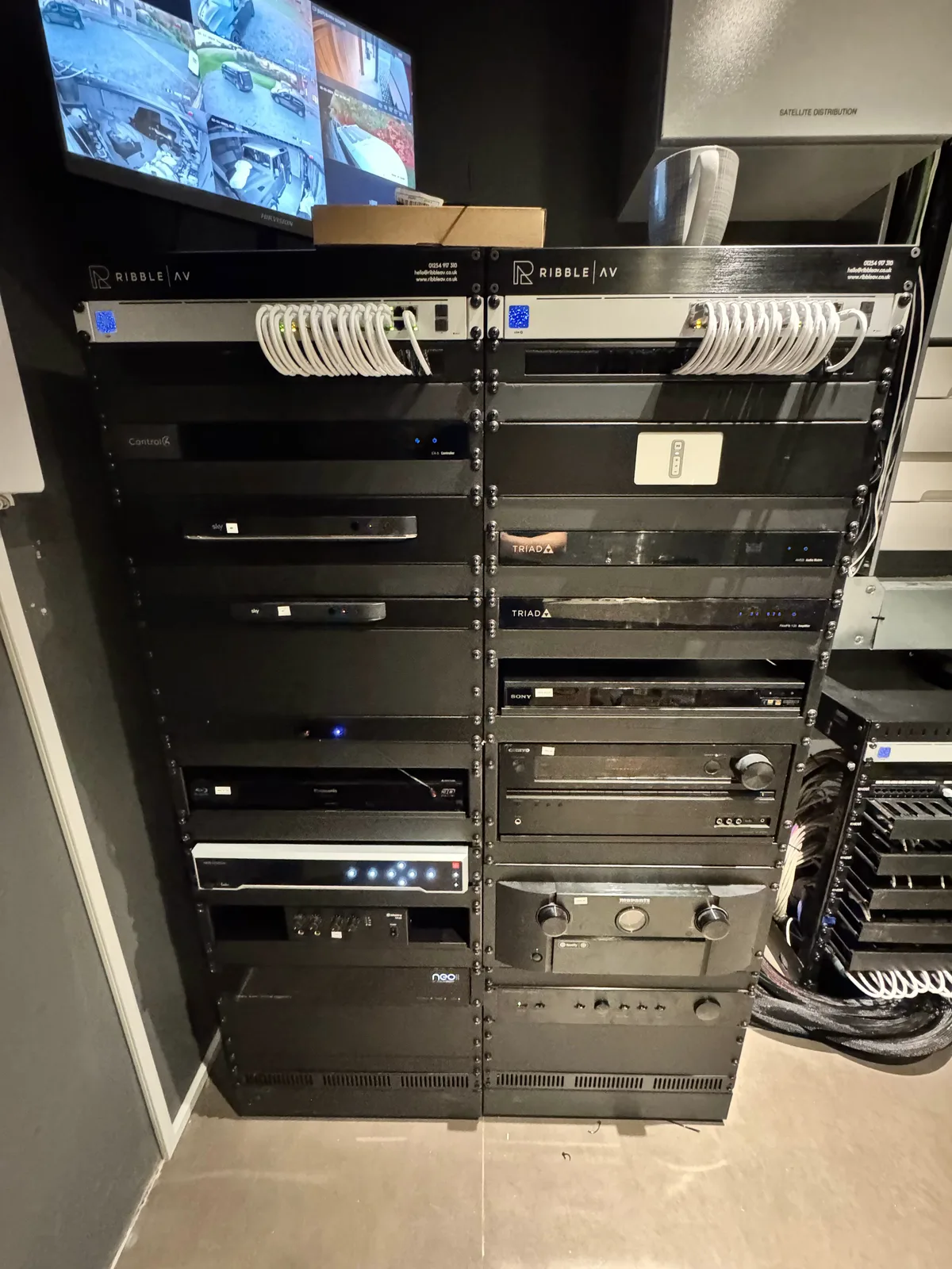 A cinema rack with processor and amplification, cabling dressed and labelled
