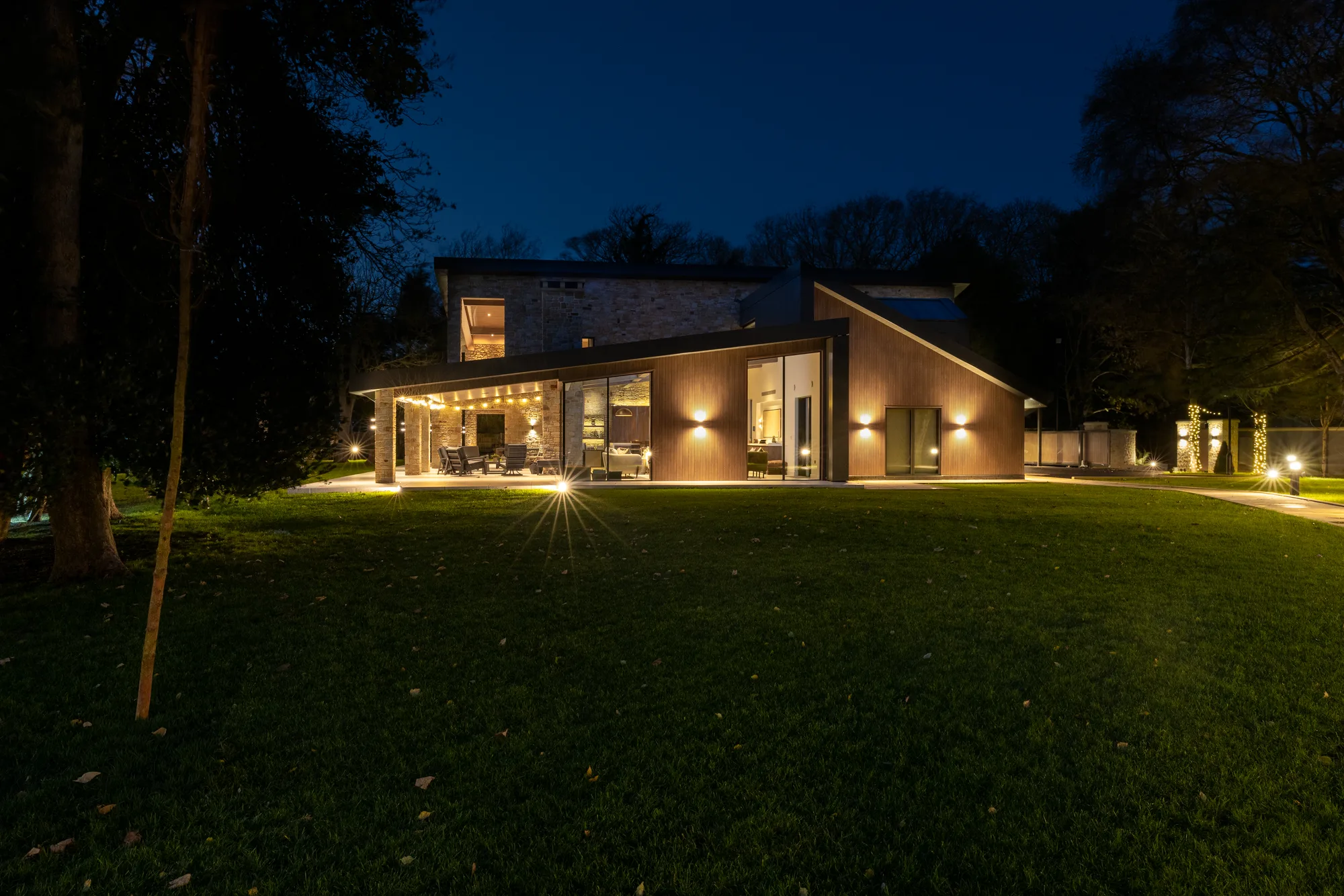 A stone house lit at dusk