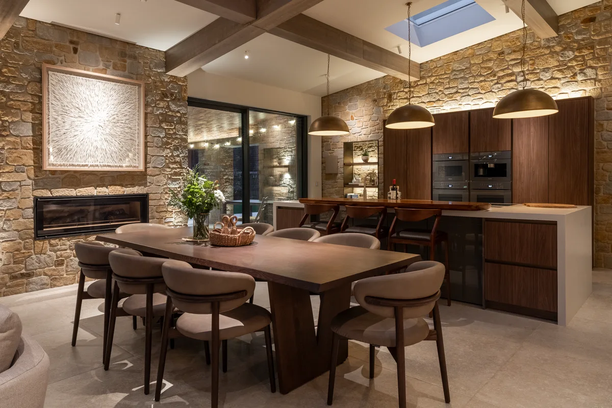 A converted barn interior with concealed speakers and a lighting scene set for evening