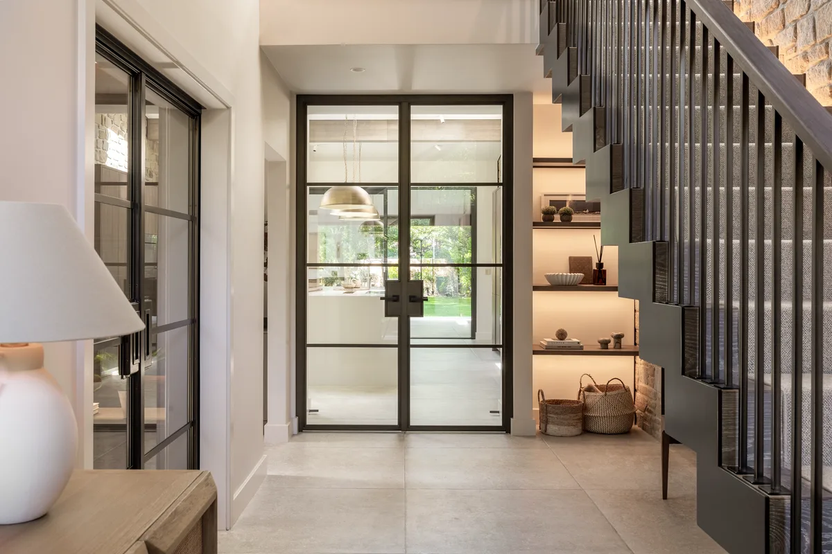 The hall looking through to the kitchen, shelving lit