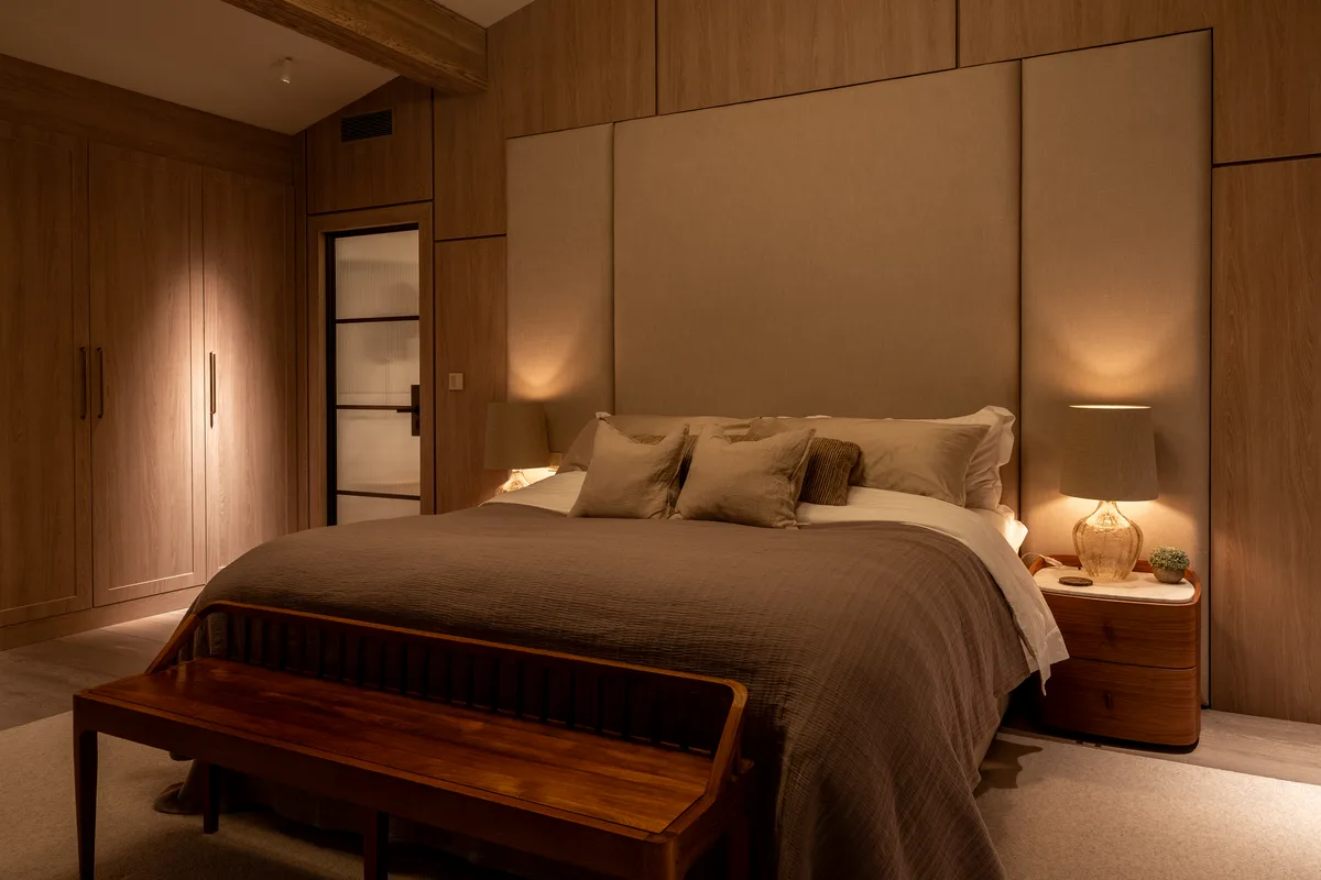 The principal bedroom lit for evening