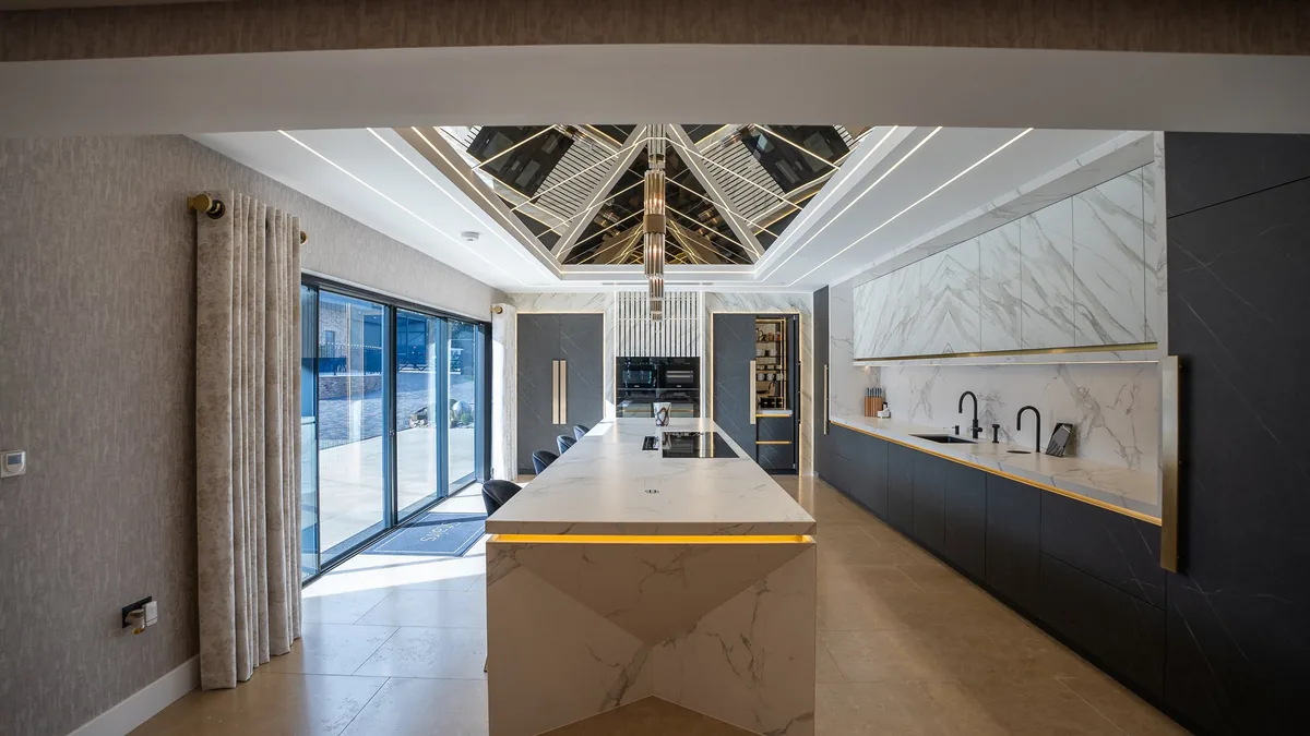 A luxury kitchen and living space at night
