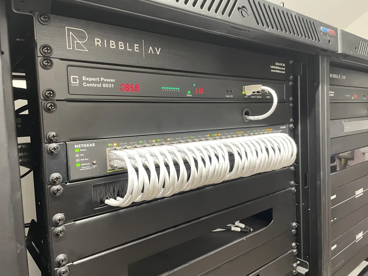 A Ribble AV branded rack fascia with patched cabling